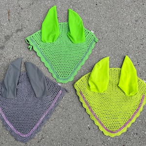 May include: Three horse fly hoods, one gray with purple trim, two lime green with pink trim.