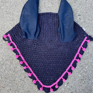 May include: Navy blue crochet fly bonnet with pink pom pom trim and matching ear bonnets.
