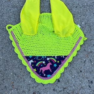 May include: A bright neon green crochet horse fly bonnet with a black and pink unicorn print lining and pink rhinestones around the edge.