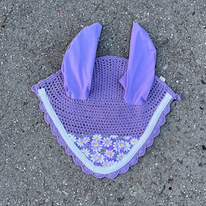 May include: A purple crochet horse fly bonnet with white lace trim and a floral print lining.