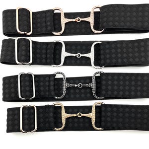 May include: Four black elastic belts with different colored jeweled horse bit buckles. The buckles are rose gold, silver, black, and gold.