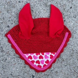 May include: Red crochet horse fly bonnet with pink heart print trim.