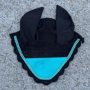 May include: Black crochet horse fly mask with turquoise satin lining and rhinestones around the edge.