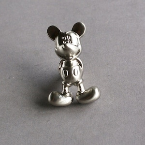 May include: Silver-toned Mickey Mouse cabinet knob with a 3D design.
