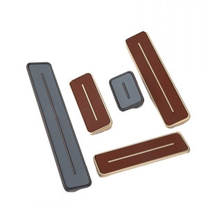 Puede incluir: Cinco tiradores de armario rectangulares de diferentes tamaños con un borde dorado y un acabado de cuero marrón. Los tiradores tienen una sola ranura horizontal.