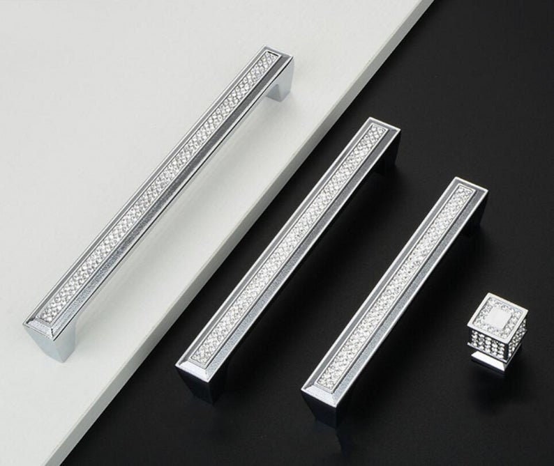 May include: Three silver cabinet pulls with a diamond-like pattern and a single silver knob with a diamond-like pattern.