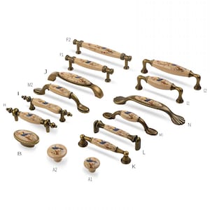 May include: Assortment of ceramic cabinet knobs and pulls with a floral design. The knobs are round and the pulls are rectangular. The knobs and pulls are in various sizes and have a gold finish.