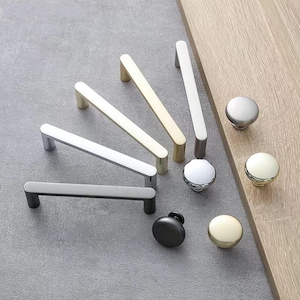 May include: Assortment of cabinet hardware in gold, silver, and chrome finishes.  The hardware includes drawer pulls and knobs in various shapes and sizes.