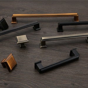 May include: Assortment of cabinet hardware in black, bronze and antique brass finishes. The hardware includes pulls and knobs in various sizes.