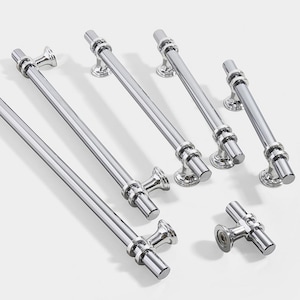 May include: A set of six chrome cabinet pulls in various sizes and styles. The pulls feature a simple, modern design with a circular accent.