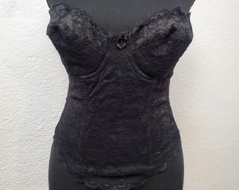May include: Black lace corset with a sweetheart neckline and boning. The corset has a smooth, satin-like finish and is designed to cinch the waist.