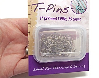 May include: A clear plastic container filled with 75 silver 1-inch (27mm) T-pins. The container is labelled "T-Pins" and "1" (27mm) T-PINs, 75 count". The label also says "Ideal for Macramé & Sewing".
