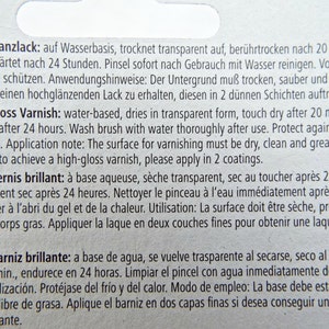 Puede incluir: Primer plano de una etiqueta blanca con texto en varios idiomas, incluyendo ingl&eacute;s, alem&aacute;n, franc&eacute;s y espa&ntilde;ol. El texto describe un barniz transparente a base de agua, que se seca en 20 minutos.
