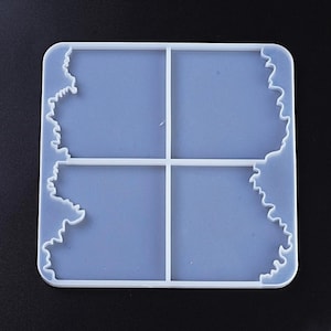 May include: A clear, square silicone mould for resin casting. The mould is divided into four equal sections with a wavy edge design on two sides. The mould is on a black background.