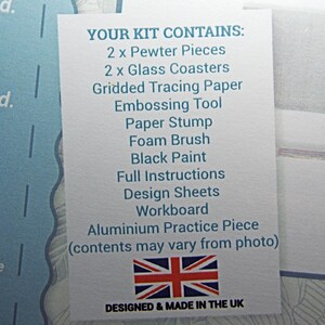May include: A white card with the text "YOUR KIT CONTAINS:" followed by a list of crafting supplies, including pewter pieces, glass coasters, tracing paper, embossing tools, a paper stump, a foam brush, black paint, full instructions, design sheets, a workboard, and an aluminum practice piece. The card also includes a small image of the Union Jack flag and the text "DESIGNED & MADE IN THE UK".