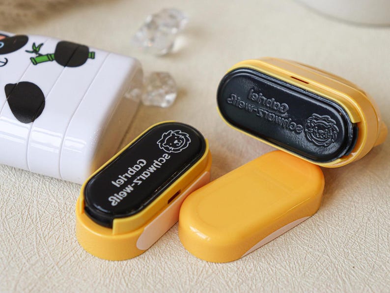 May include: Four yellow and black stampers with a lion design and the text "Schwalz-wei&szlig;" and "Gabriel" on the black part.