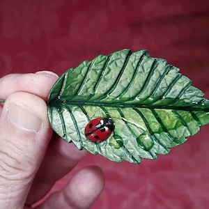 realistic ladybird on leaf sculpture