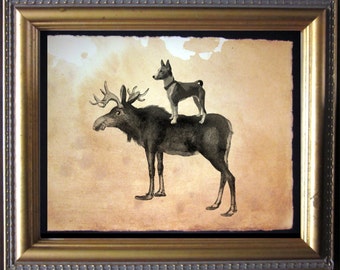 May include: A framed illustration of a black and white moose with a black and white dog standing on its back. The background is a light brown color.