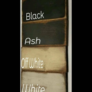 Six wooden planks painted in different colors: cranberry, black, ash, off white, white, and soapstone. The colors are labeled on each plank.