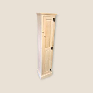 May include: Tall, narrow wooden cabinet with a single door. The cabinet is made of light-colored wood, possibly pine or maple, and features black hinges and a wooden knob. The design is simple and functional, suitable for storage.