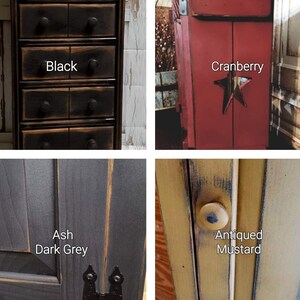 Four different color options for a wooden cabinet. The first cabinet is black with five drawers and the text 'Black'. The second cabinet is red with a star cutout and the text 'Cranberry'. The third cabinet is dark gray with the text 'Ash Dark Grey'. The fourth cabinet is yellow with the text 'Antiqued Mustard'.