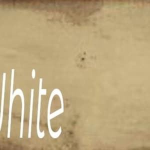 A close-up of a light beige painted wood surface with the text 'Off White' written in white font.