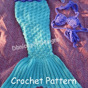May include: Crochet mermaid tail pattern with a turquoise tail, purple top and headband with a starfish. The pattern is called "Dbnicegirl Designs Crochet Pattern".