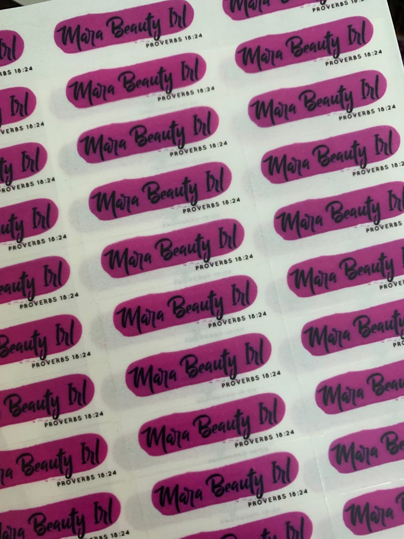 May include: A sheet of stickers with the text "Mara Beauty Irl" and "Proverbs 18:24" repeated on each sticker. The stickers are pink and white with a brushstroke effect.