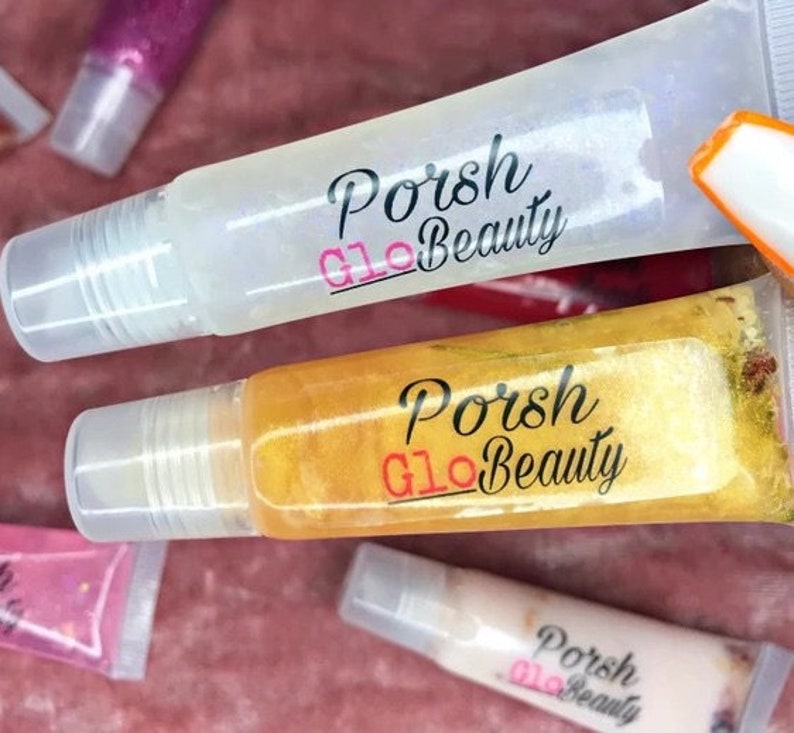 May include: Two clear lip gloss tubes with gold and silver glitter. The tubes are labeled "Porsh Glo Beauty".
