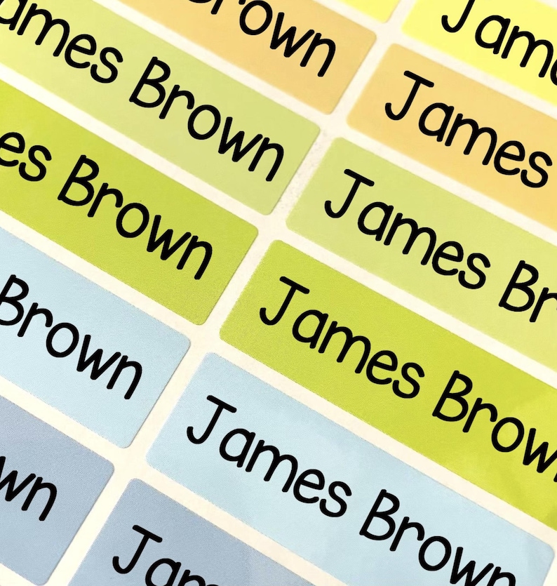 May include: A collection of rectangular adhesive labels in various pastel colors including yellow, lime green, and light blue. Each label features the name James Brown printed in a bold, black, sans-serif font, arranged in a grid pattern on a sheet.