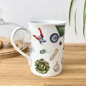 Gardening bone china mug with garden tools, vegetables, flowers and ladybirds on the outside.