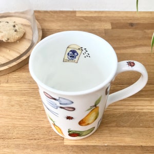 Gardening bone china mug with a small packet of pansy seeds on the inside
