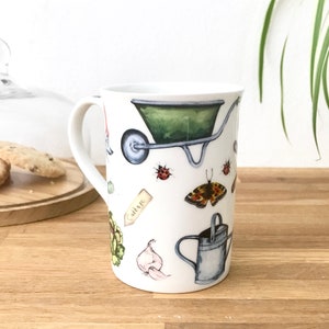 Gardening bone china mug with garden tools, vegetables, flowers and ladybirds on the outside.