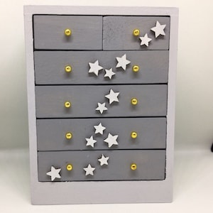 Handmade 1:12th scale miniature dolls house furniture. Modern chest of drawers with falling stars
