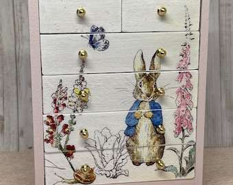 Handmade 1:12th scale miniature dolls house furniture chest of drawers painted pink and finished with Peter Rabbit themed decals