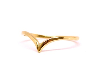 May include: A gold-colored ring with a V-shaped design.