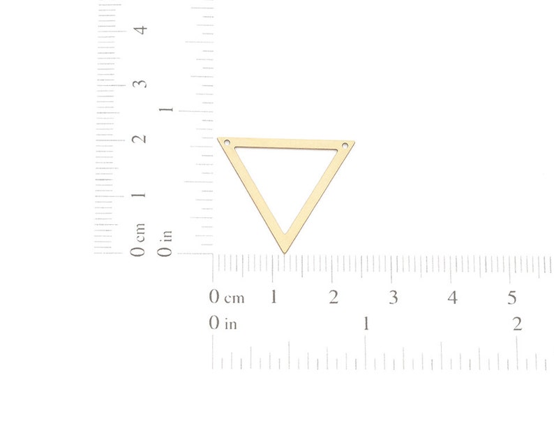 May include: Gold triangle pendant with two holes at the top. The pendant is approximately 2 inches wide.