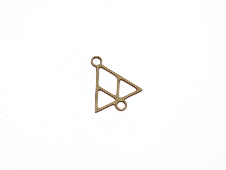 May include: Gold-toned metal triangle charm with a geometric design. The charm has two holes for attaching to jewelry.