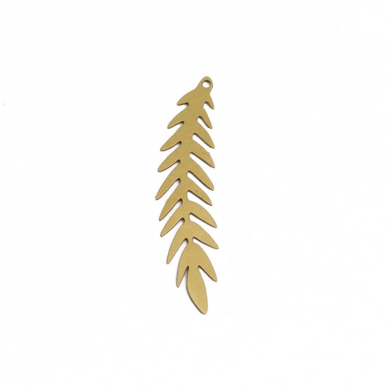 May include: A gold-colored metal leaf charm with a detailed fern-like design. The charm is perfect for adding a touch of nature to jewelry projects.