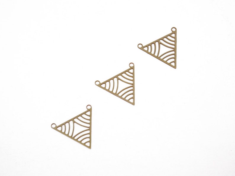 May include: Three gold-toned metal triangle charms with a geometric design. Each charm has three holes for attaching to jewelry.
