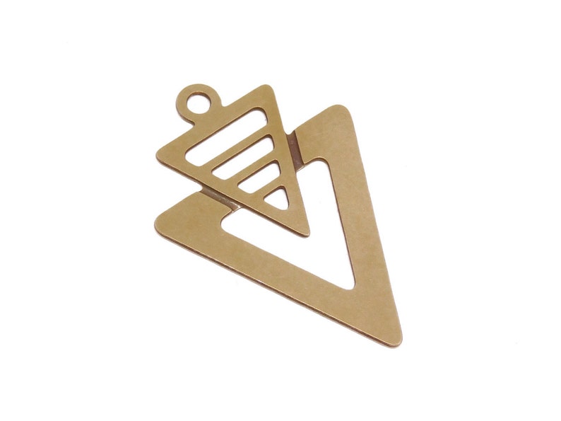May include: Gold-toned metal pendant with a geometric design featuring two overlapping triangles. The larger triangle has a cutout in the shape of a smaller triangle.
