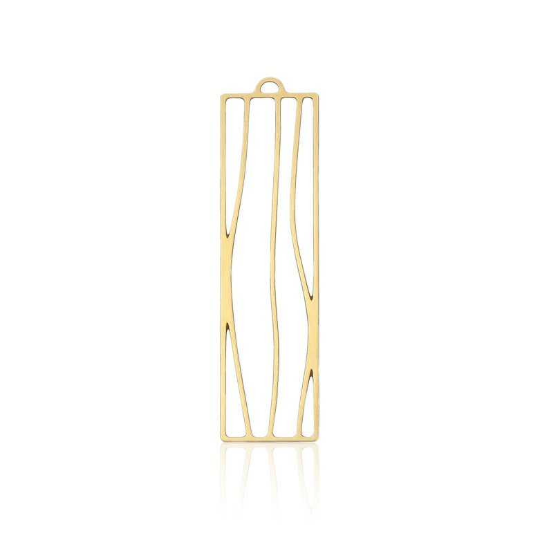 May include: Gold-toned metal pendant with a rectangular shape and a cutout design resembling tree branches.