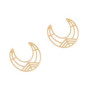 May include: Two gold-colored, crescent-shaped earring components. Each component features a geometric design with a series of straight lines and angles, creating an open, airy appearance. The earrings have small holes at the top for attachment.