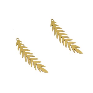 May include: Two gold-colored metal leaf charms. Each charm is shaped like a fern leaf with a pointed tip and a hole at the top for attaching to jewelry.
