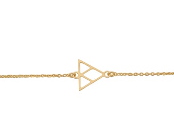 May include: A gold chain bracelet with a geometric triangle pendant.