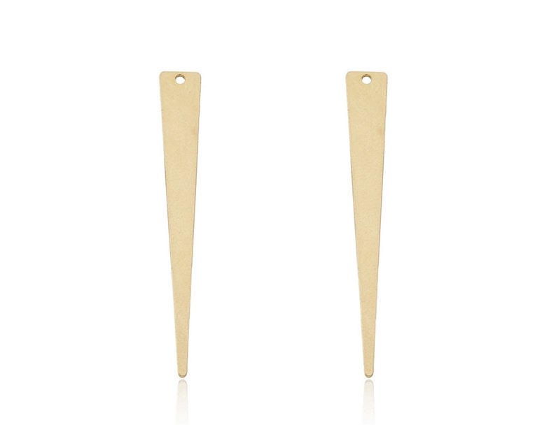 May include: Two gold-colored metal earring findings with a pointed tip and a small hole at the top.