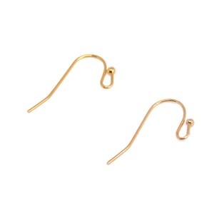May include: Two gold earring hooks with a small ball at the end of each hook.