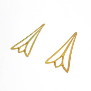 May include: Two gold-colored metal earring findings with a delicate, floral-inspired design. The findings are shaped like a pointed leaf with three rounded petals at the bottom.