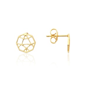 May include: A pair of gold-colored stud earrings. The earrings feature a geometric, openwork design. One earring is shown from the front, and the other is shown from the side, displaying the post and butterfly backing. The earrings are set against a white background.