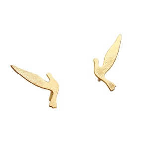 May include: A pair of gold-toned earrings shaped like flying birds.